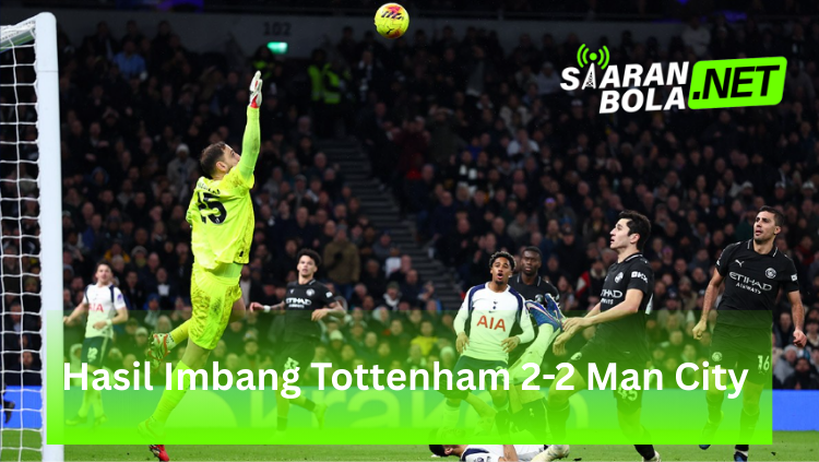Kiper Tottenham Hotspur berbaju kuning neon melompat tinggi untuk menghalau bola di depan gawang, sementara pemain Manchester City berbaju hitam dan pemain Tottenham berbaju putih (AIA) melihat ke arah bola, terdapat logo SIARANBOLA.NET di pojok kanan atas dan teks "Hasil Imbang Tottenham 2-2 Man City" pada bilah hijau di bagian bawah.