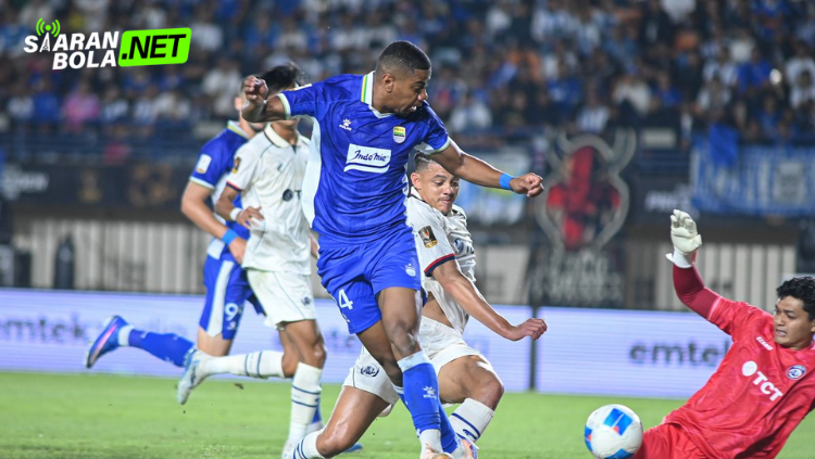 Pemain Persib Bandung berlari menggiring bola sambil dikawal ketat pemain lawan pada pertandingan Liga 1 Indonesia di stadion.